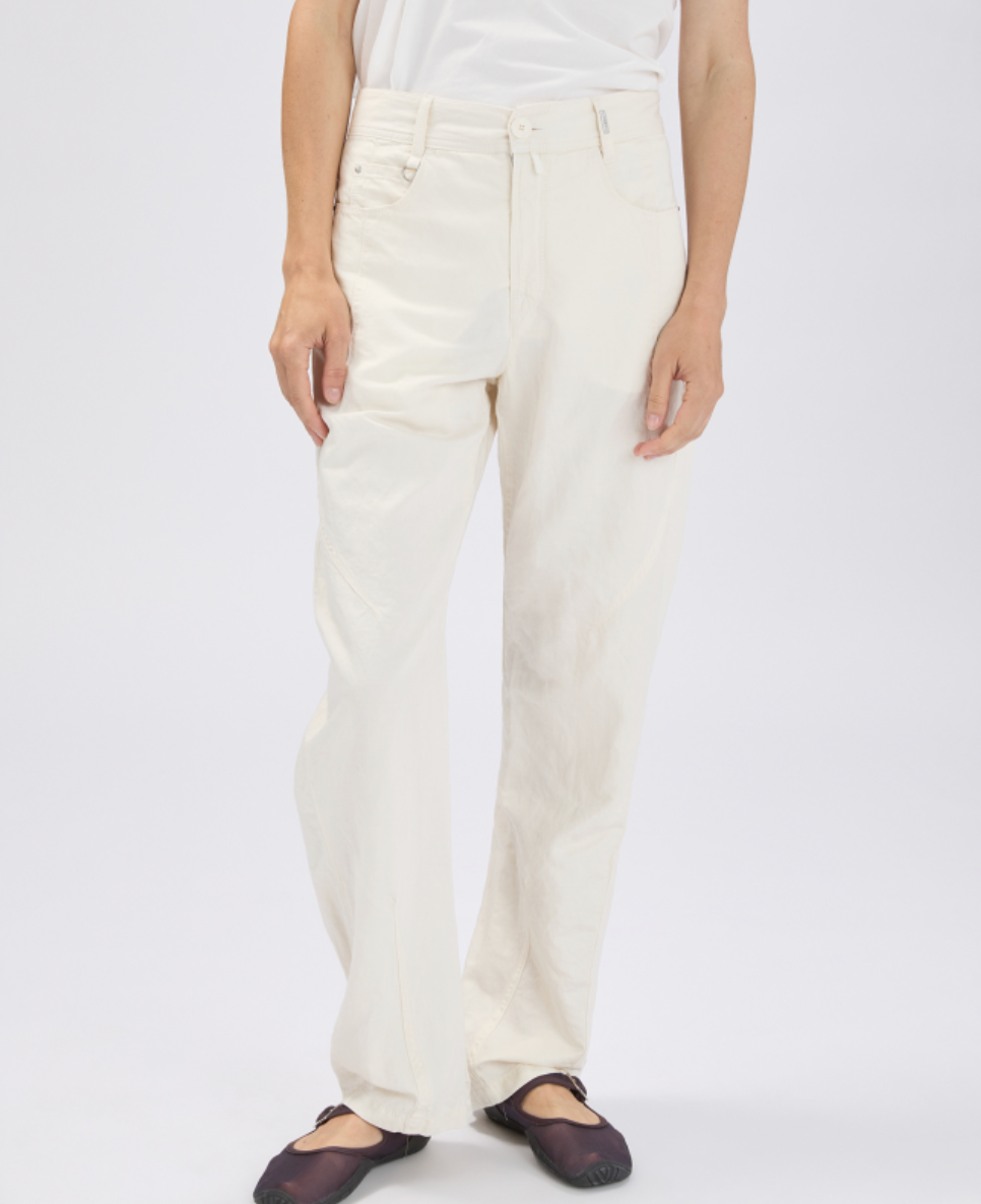 Person wearing white pants on a plain background