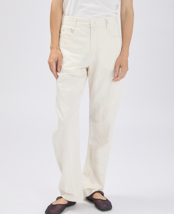 Person wearing white pants on a plain background