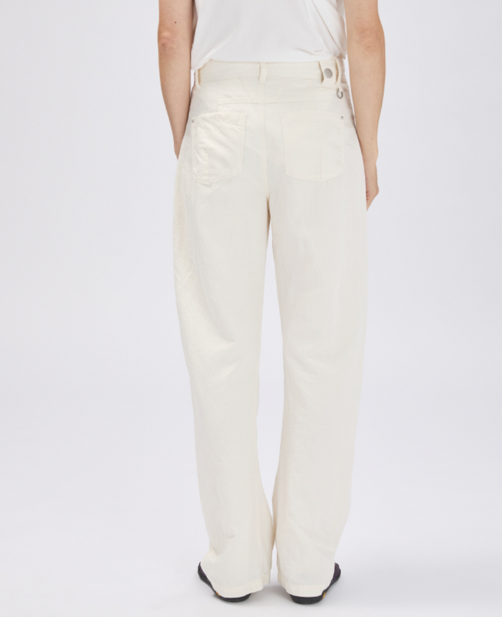 White pants worn by a person on a white background