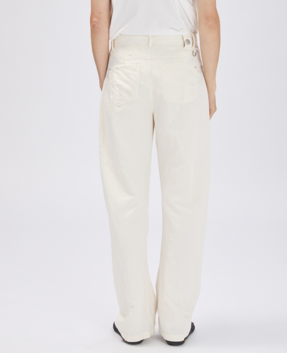 White pants worn by a person on a white background