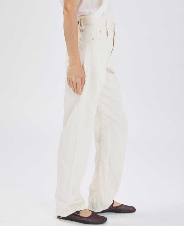 Person wearing white pants on a plain background