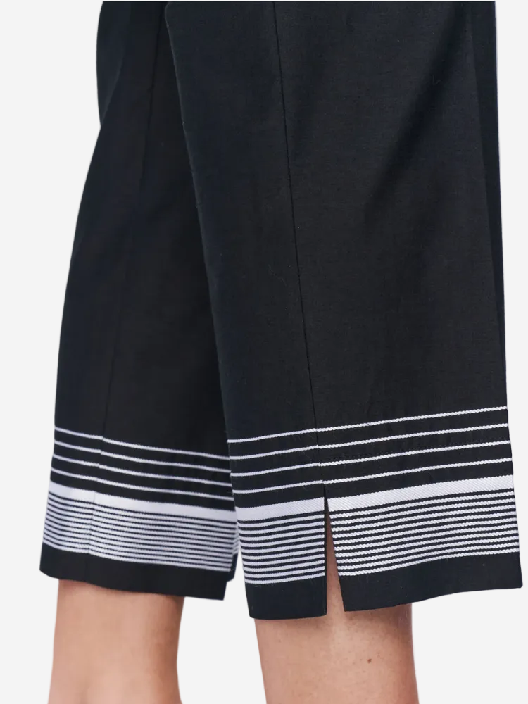Black skirt with white striped hem on a plain background