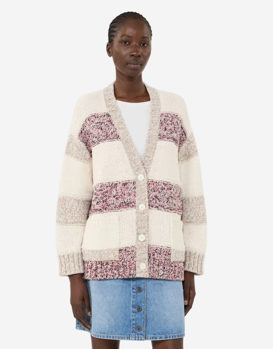 Woman wearing a patchwork cardigan with floral patterns on a white background