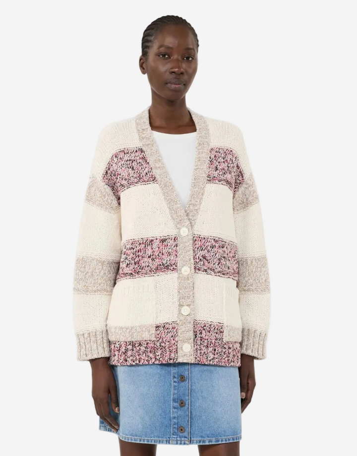 Woman wearing a patchwork cardigan with floral patterns on a white background