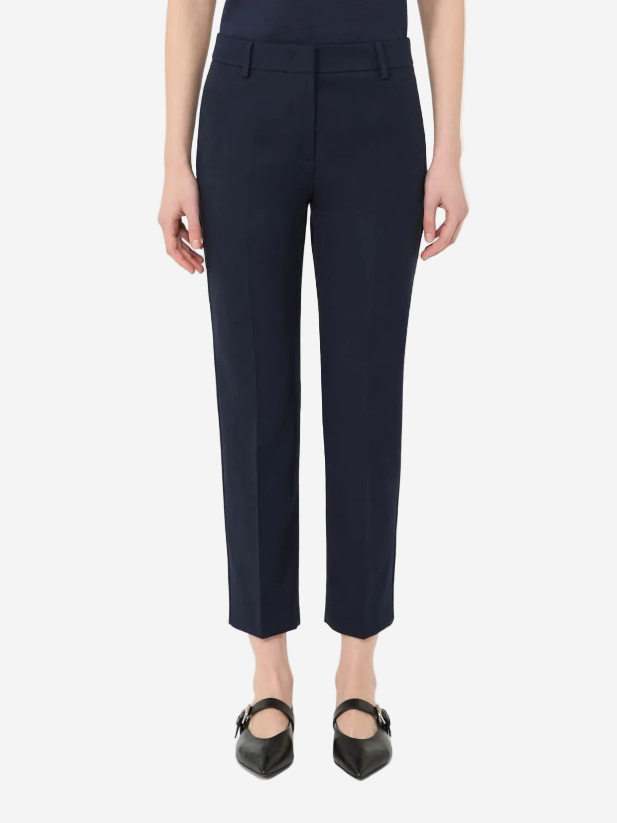 Navy blue pants worn by a person on a white background