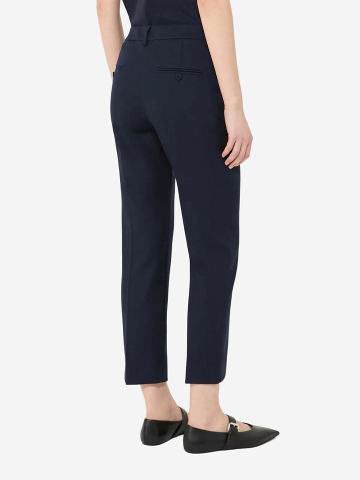 Navy blue pants worn by a person on a white background