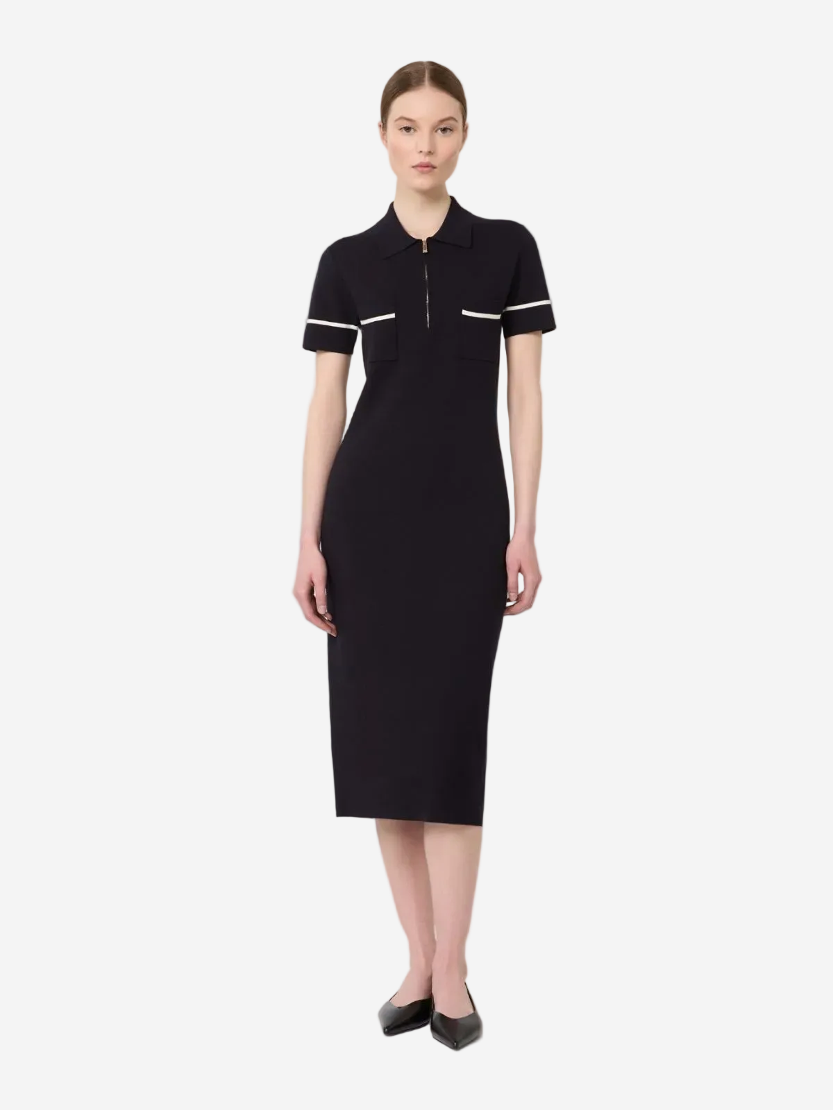 Woman wearing a black dress with white trim on a white background