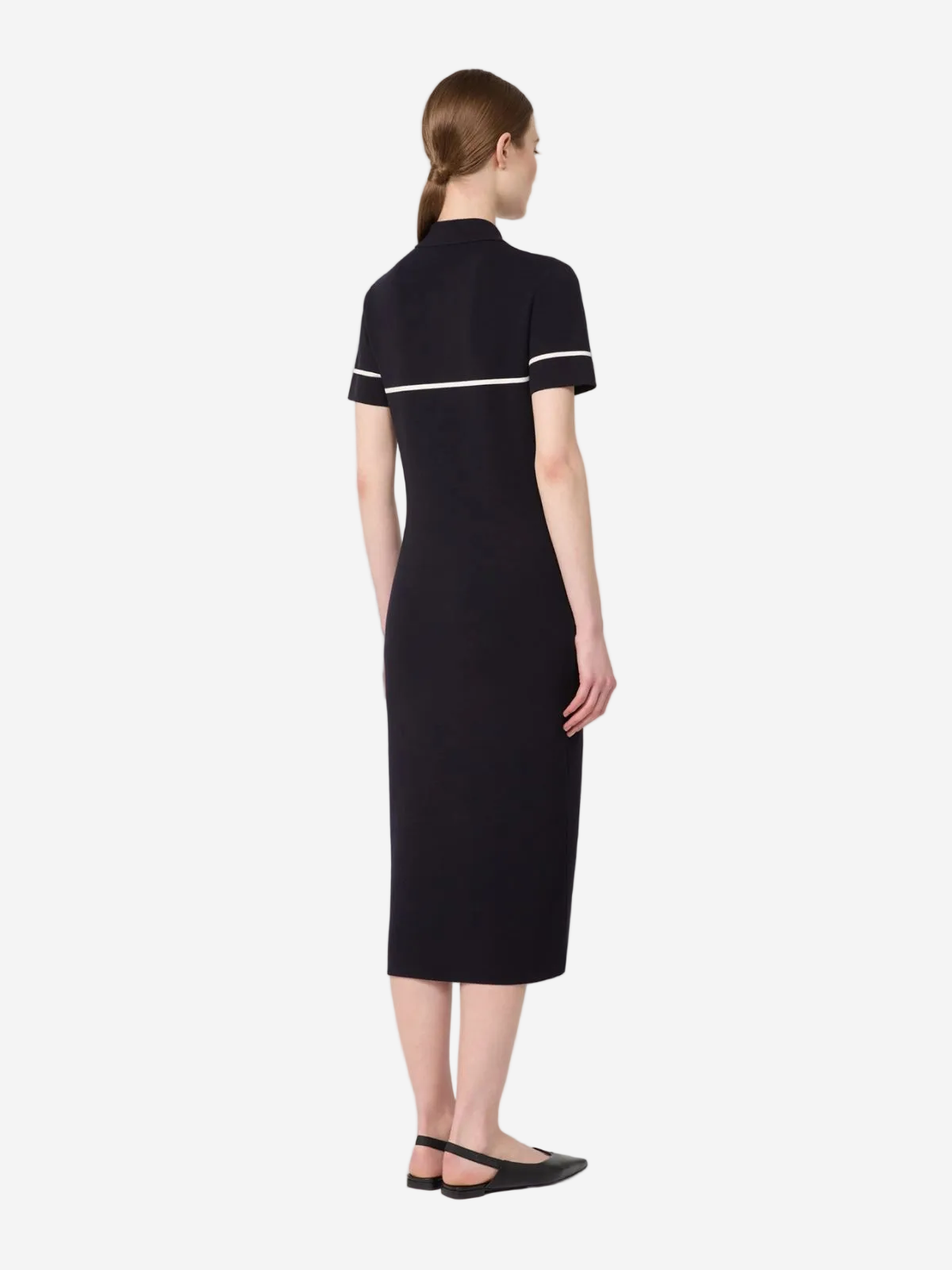 Woman wearing a black dress with white trim on a white background available in Australia at Christensen Copenhagen