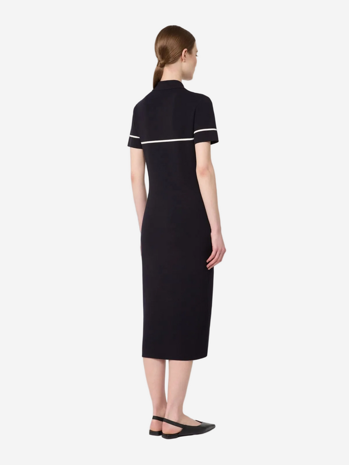 Woman wearing a black dress with white trim on a white background available in Australia at Christensen Copenhagen