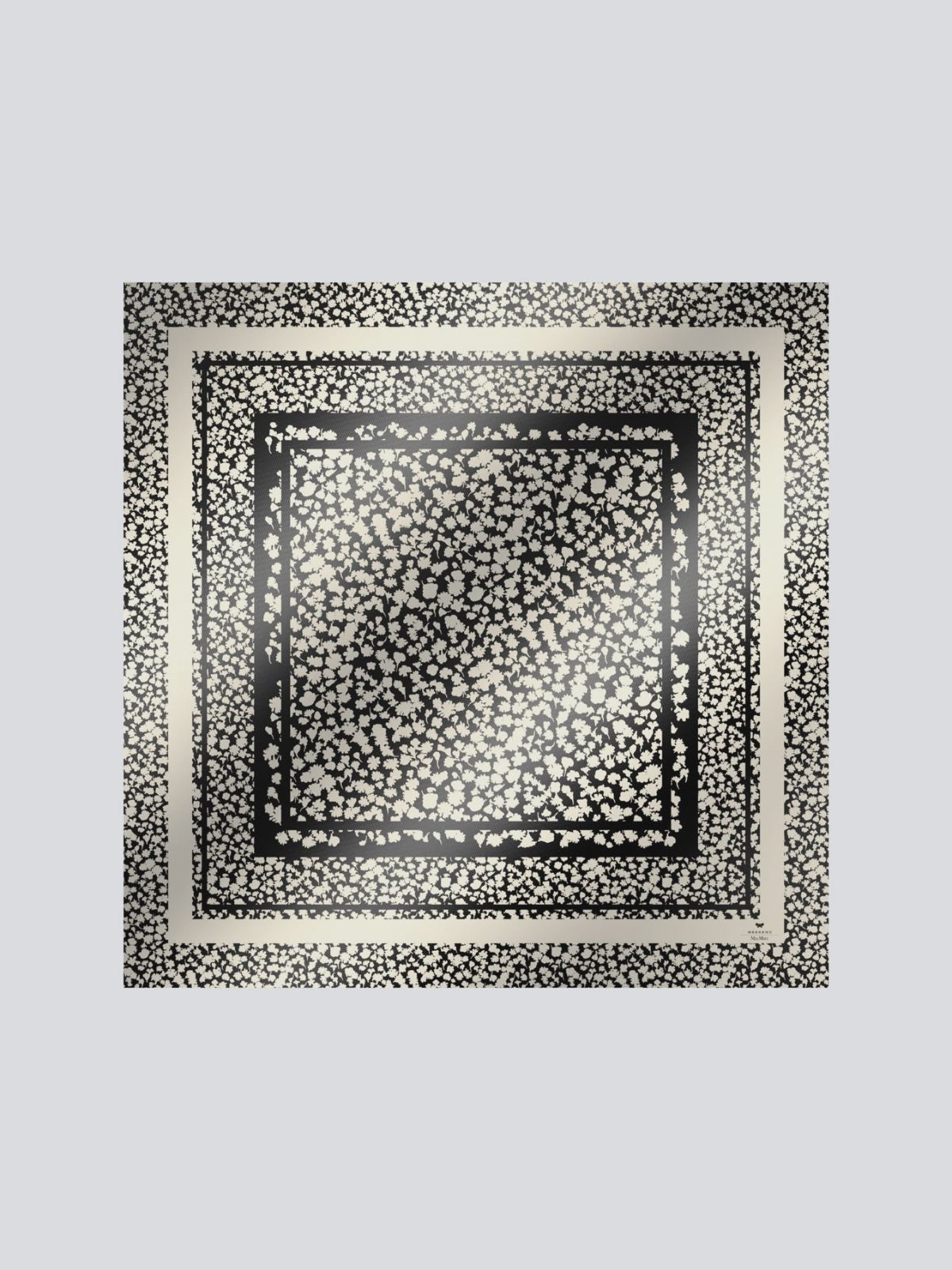 Black and white patterned square scarf on a light gray background