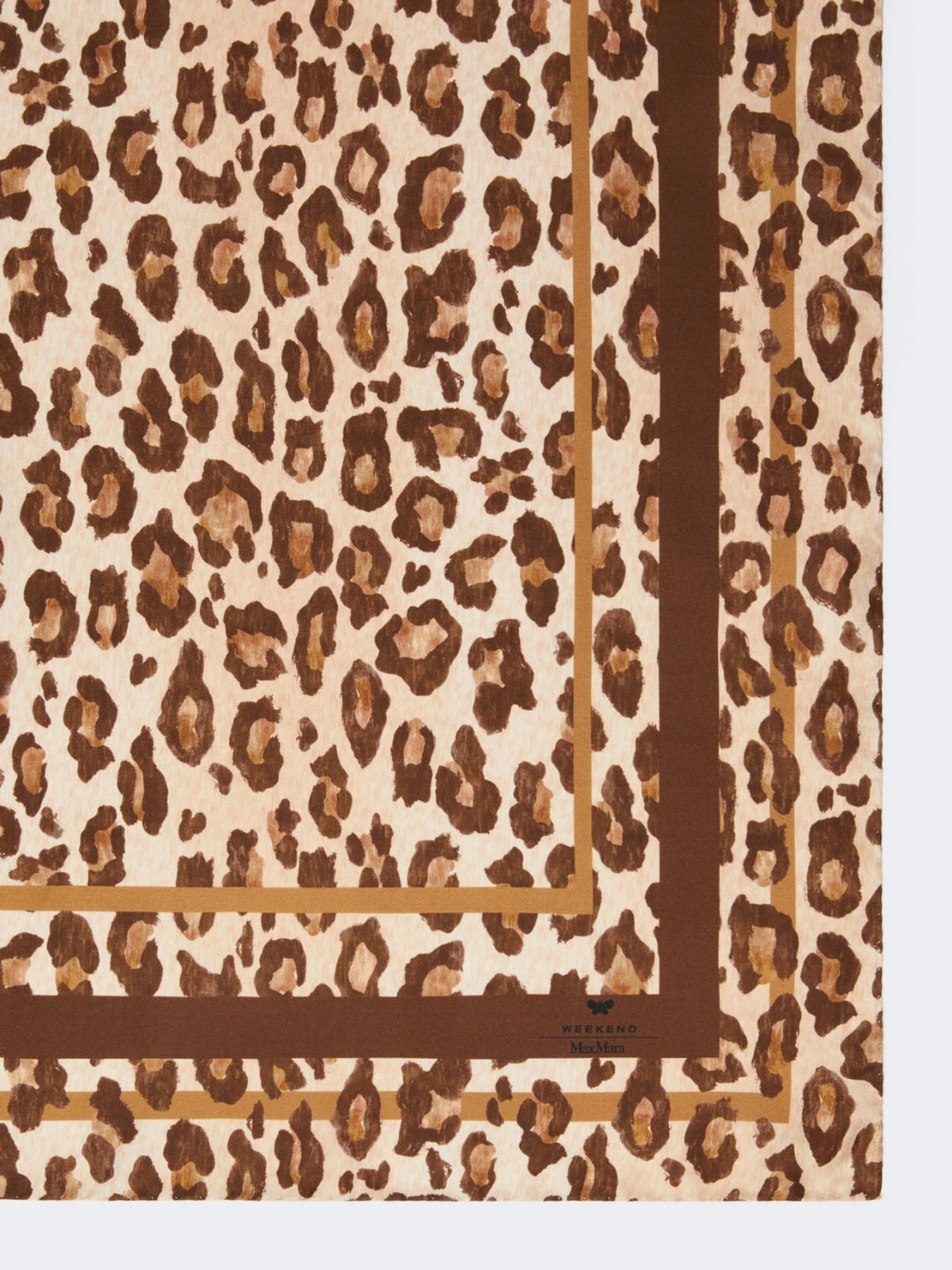 Leopard print fabric with a brown border on a beige background