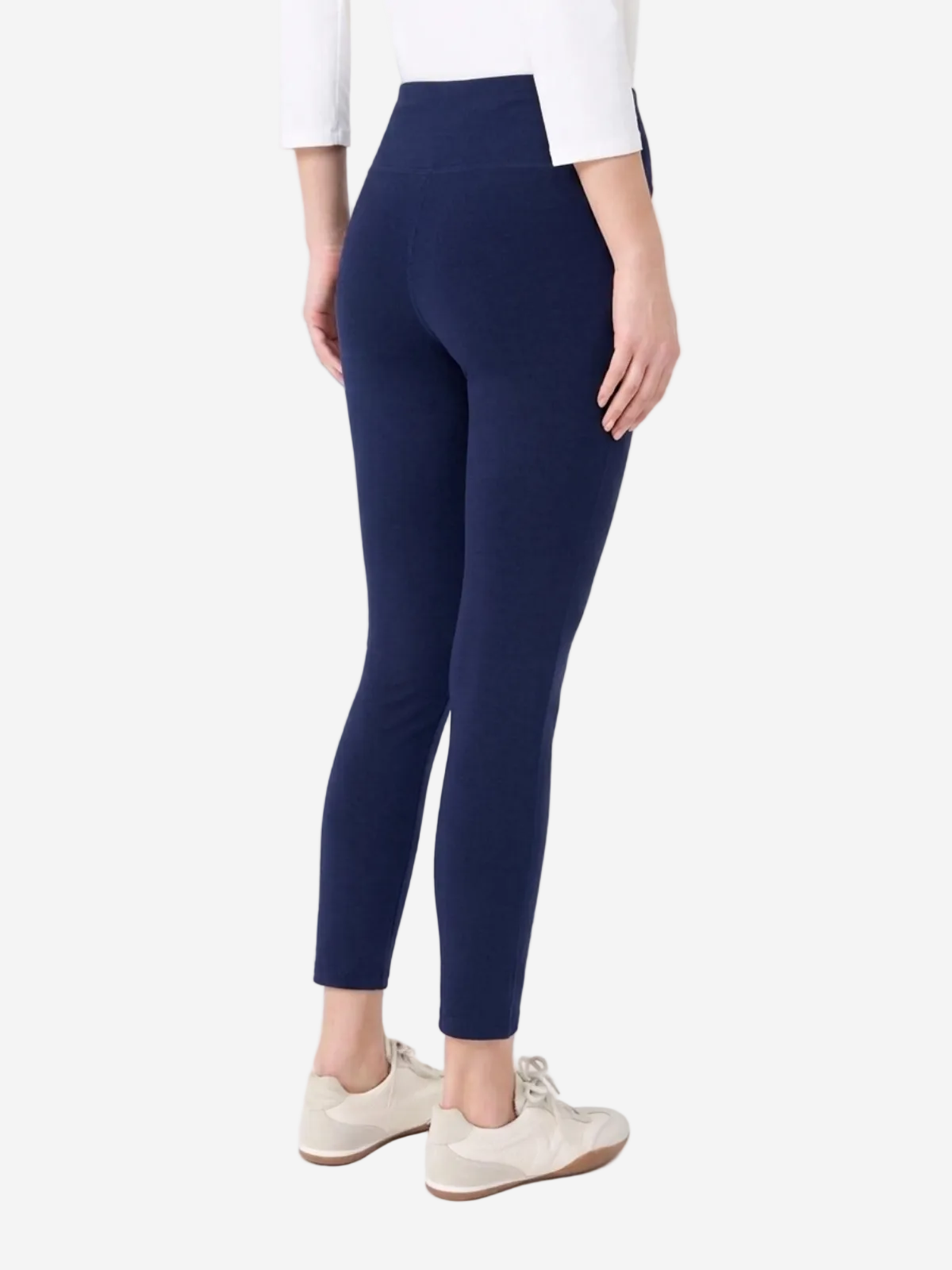 Person wearing navy leggings on a white background
