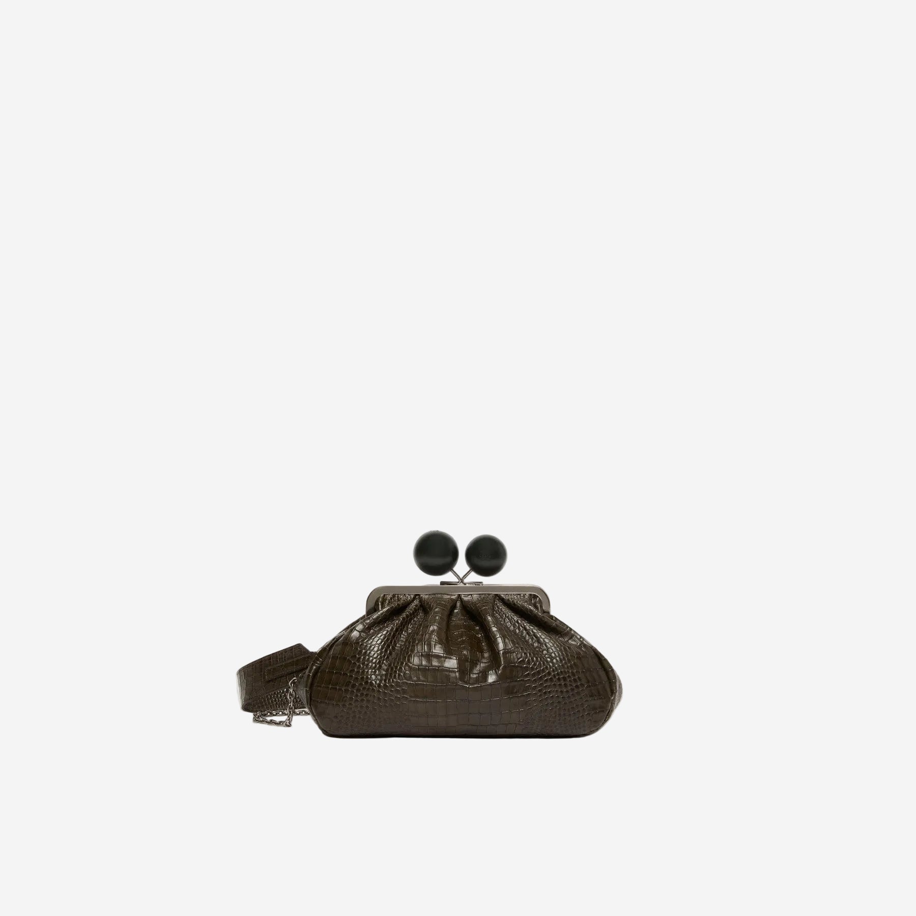 Brown clutch bag with black pom-pom details on a white background
