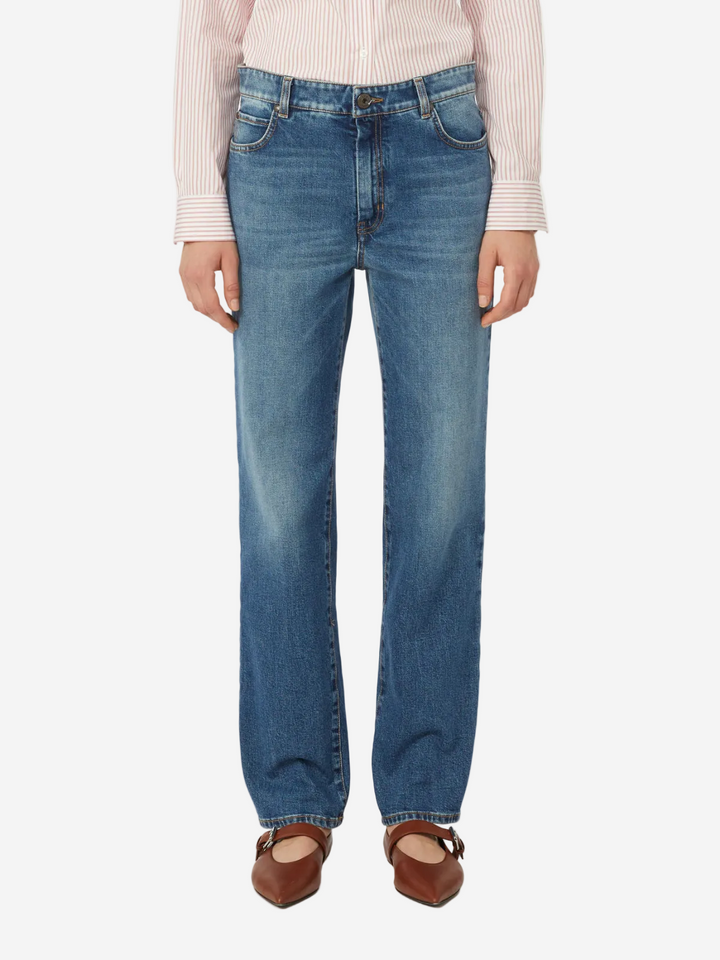 Person wearing blue jeans on a white background