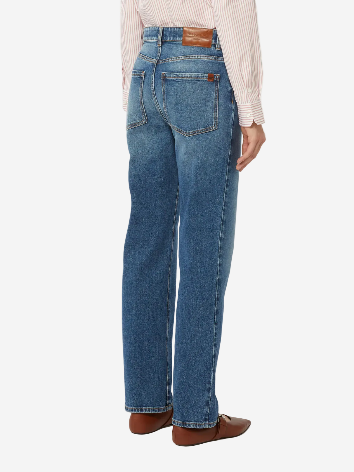 Person wearing blue jeans on a white background