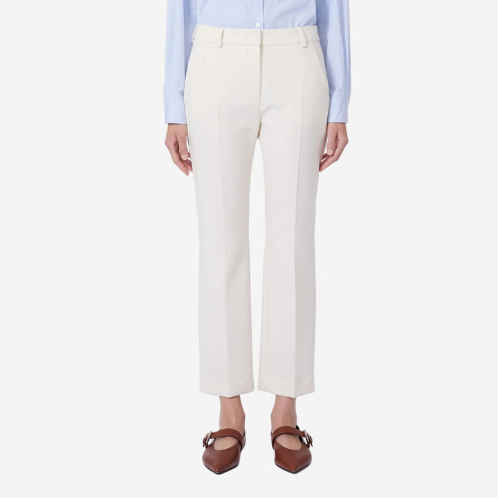 Person wearing white pants and a light blue shirt on a white background