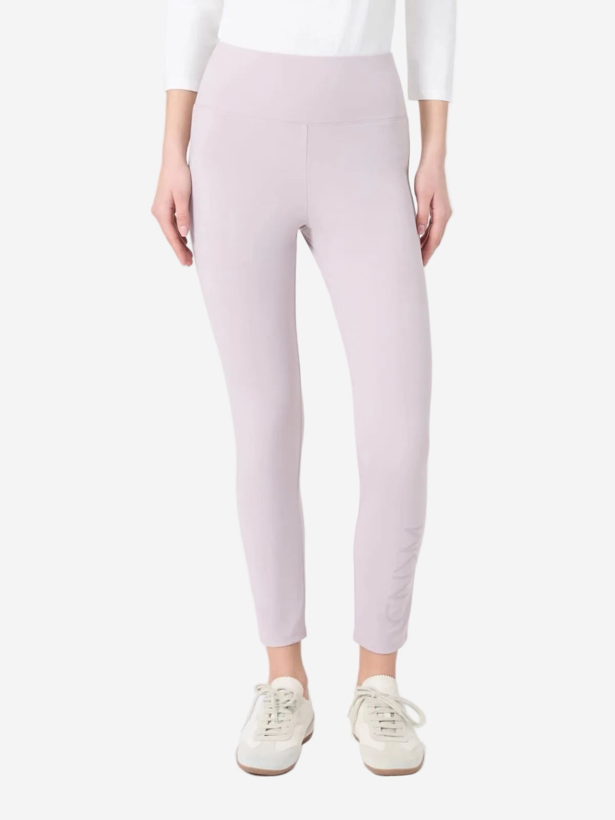 Person wearing light pink leggings on a white background
