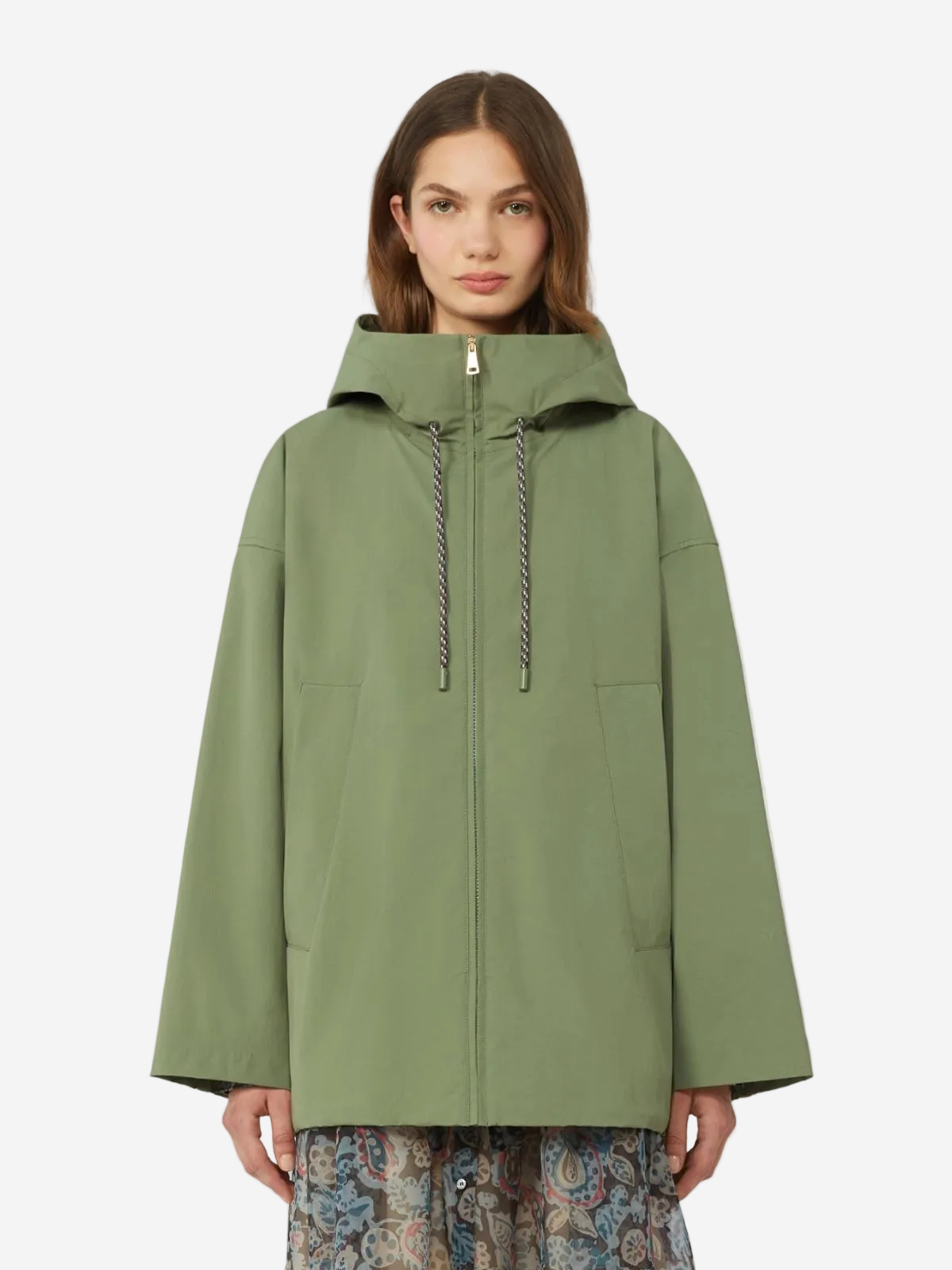 Woman wearing a green raincoat on a white background