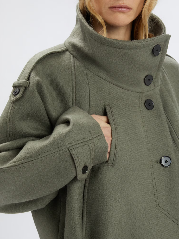 Woman wearing a green jacket on a white background