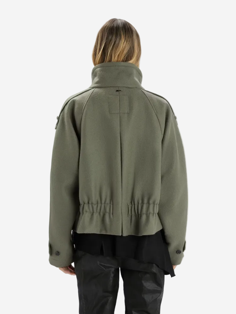 Person wearing a green jacket on a white background