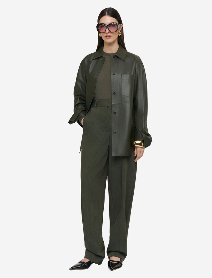 Person wearing a green outfit with a white background