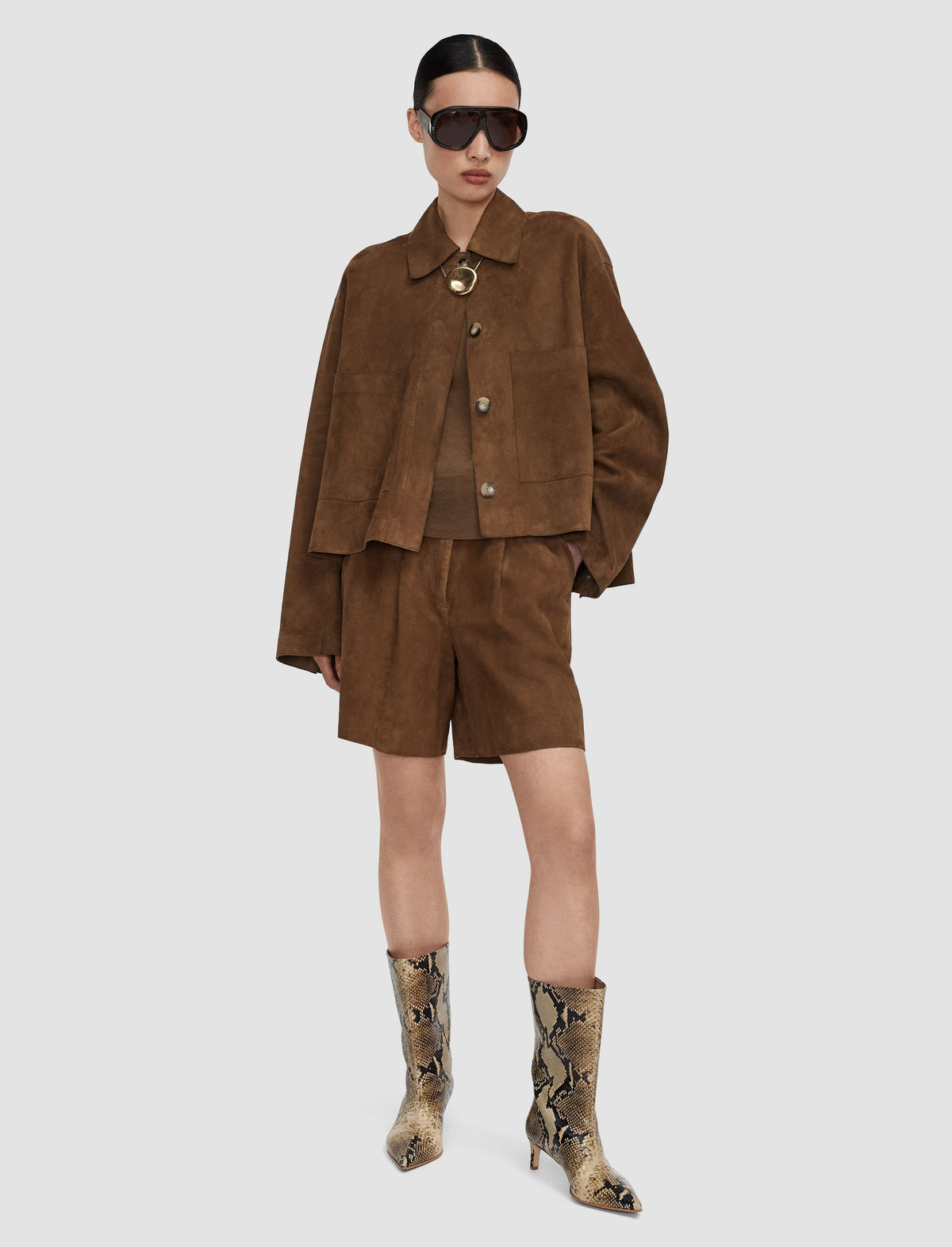 A model wearing a brown suede cropped jacket and matching shorts from Christensen Copehagen. 