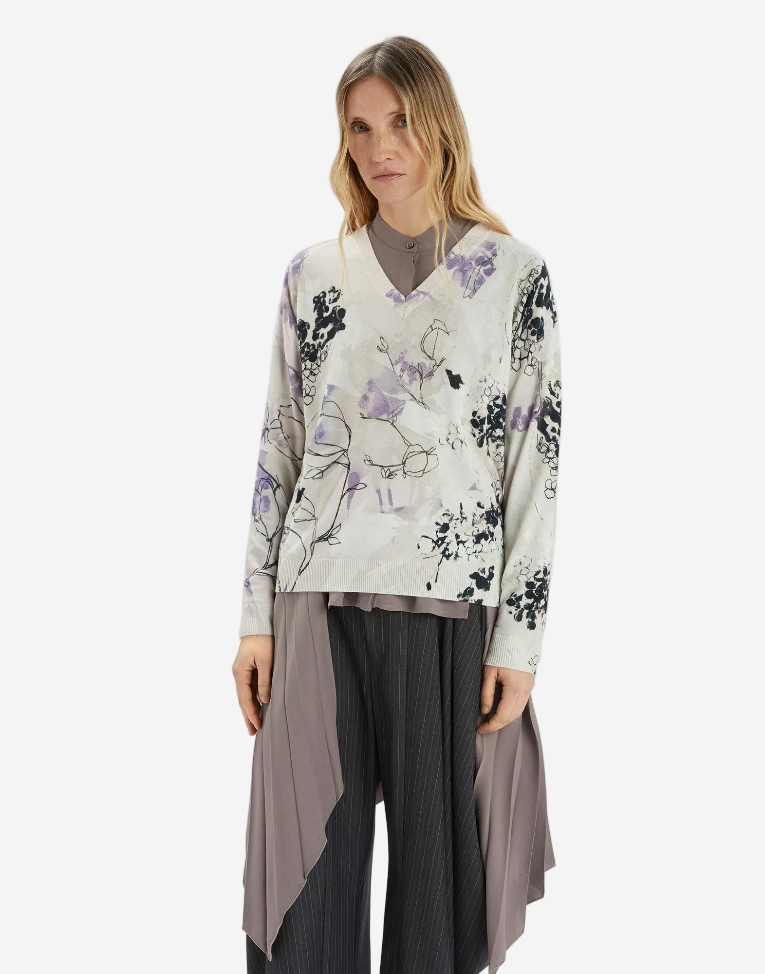 Woman wearing a floral blouse with a plain background