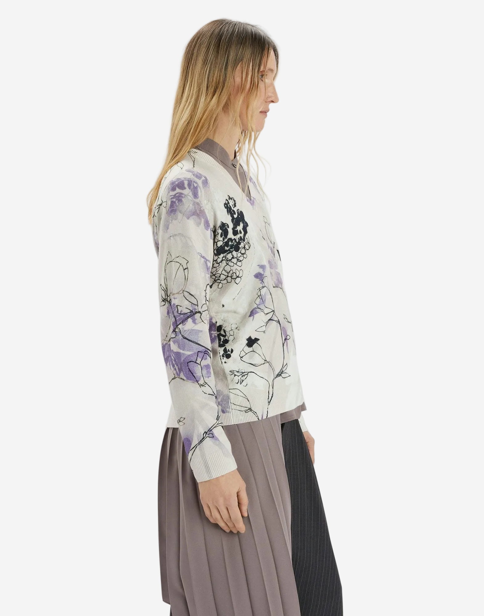 Woman wearing a floral-patterned cardigan on a white background