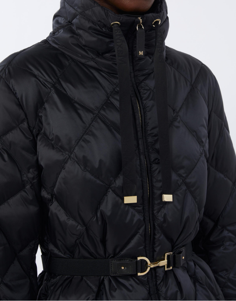 Black quilted jacket with a gold buckle on a white background