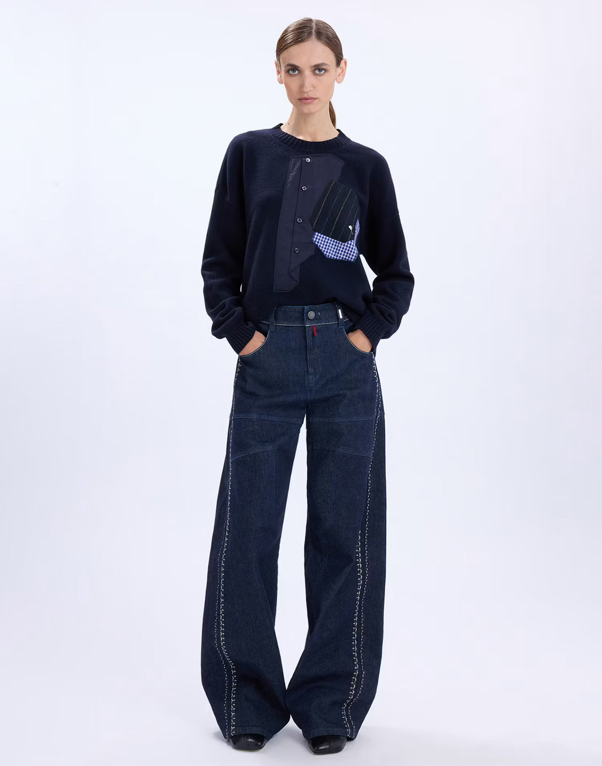 Model wearing the HIGH Casually navy sweater with wide-leg dark denim jeans, full-length front view