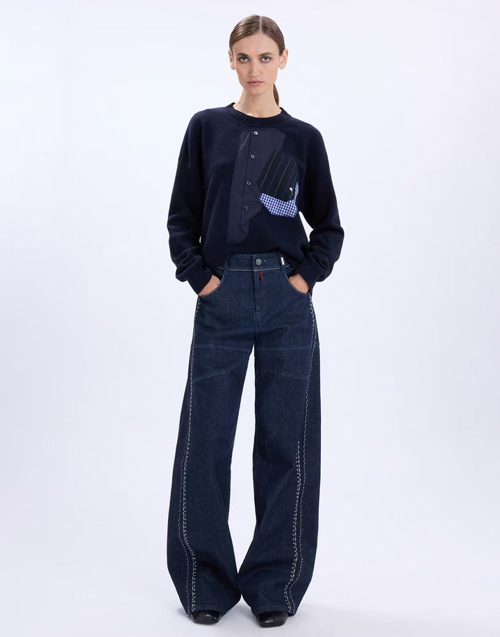 Model wearing the HIGH Casually navy sweater with wide-leg dark denim jeans, full-length front view