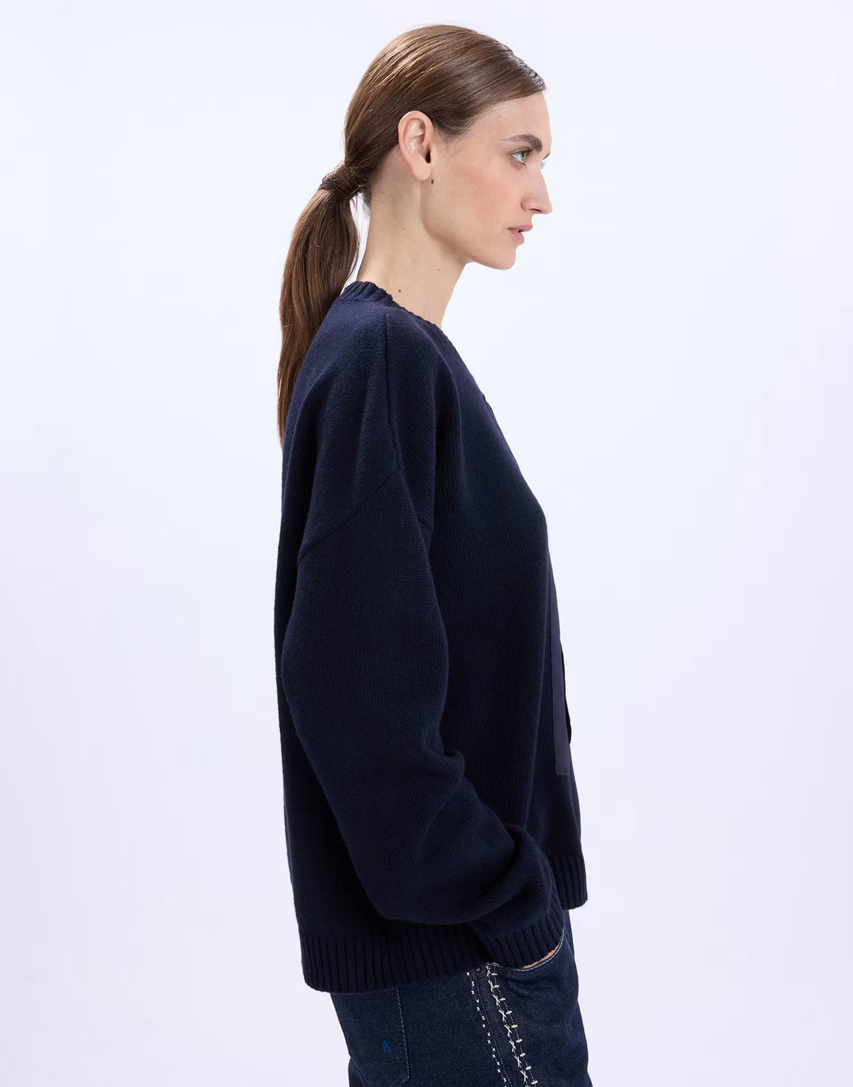 Side view of the HIGH Casually sweater showing the relaxed fit and dropped shoulder