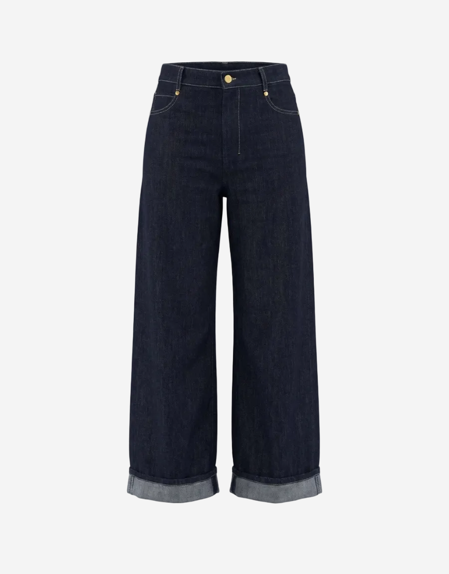 Dark blue jeans with rolled-up hem on a white background