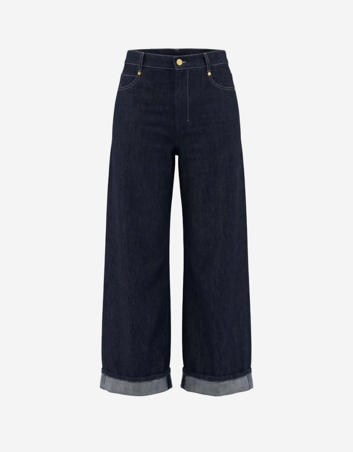 Dark blue jeans with rolled-up hem on a white background