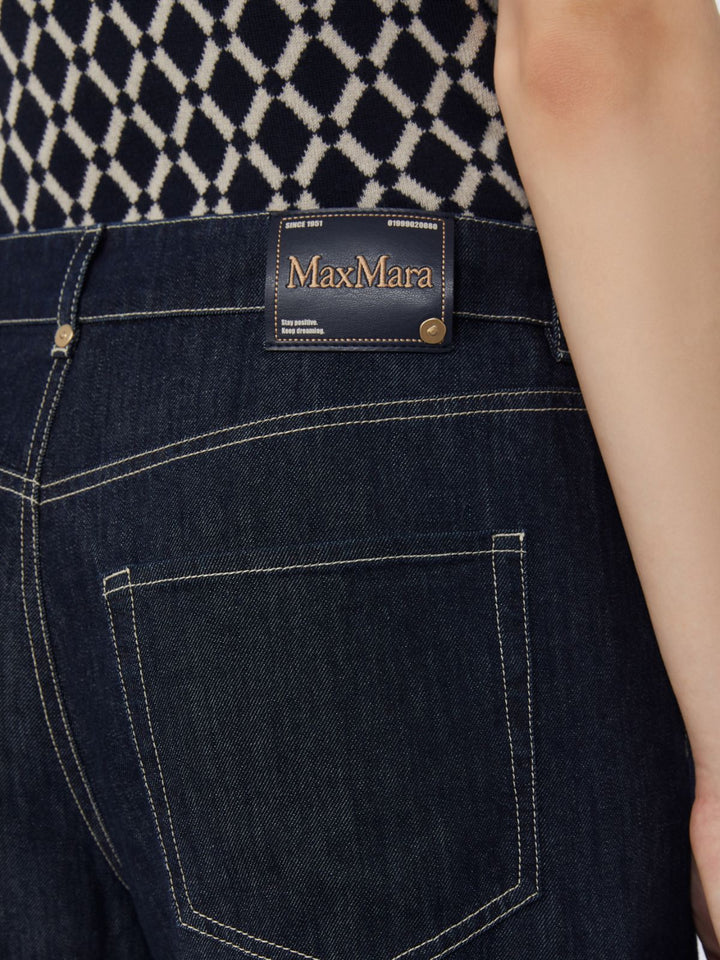 Dark blue jeans with Max Mara label on a patterned background