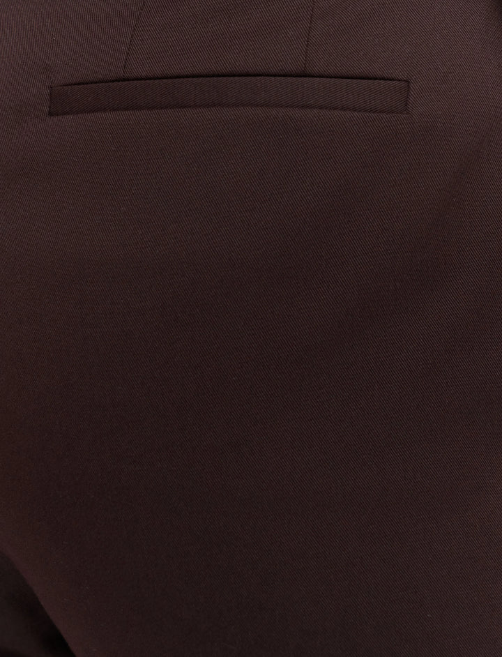 Close-up of a brown suit pocket with a plain background