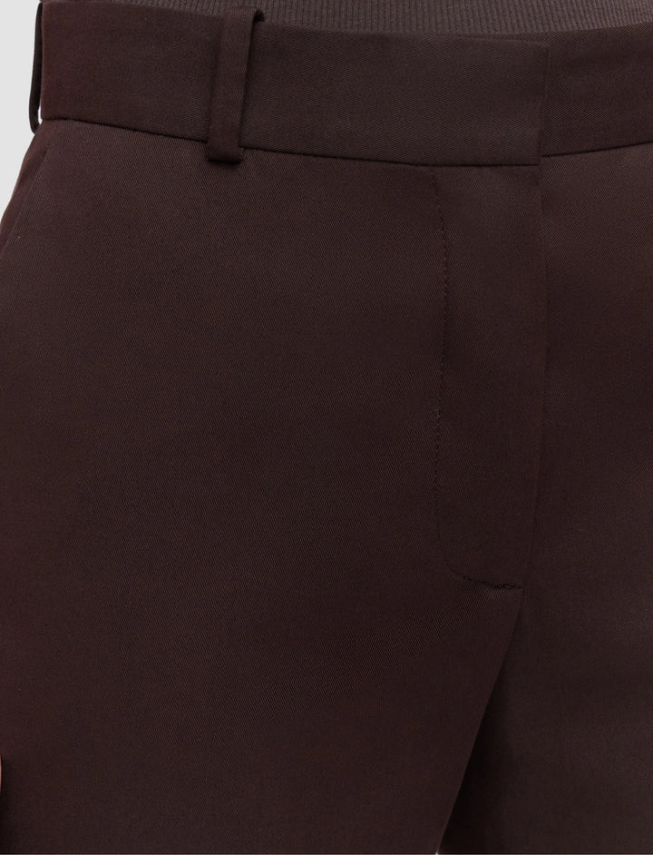 Close-up of brown pants with a white background