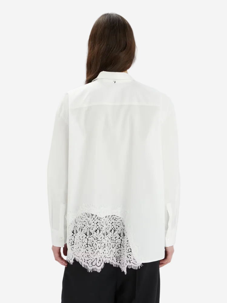 White blouse with lace detailing on a white background