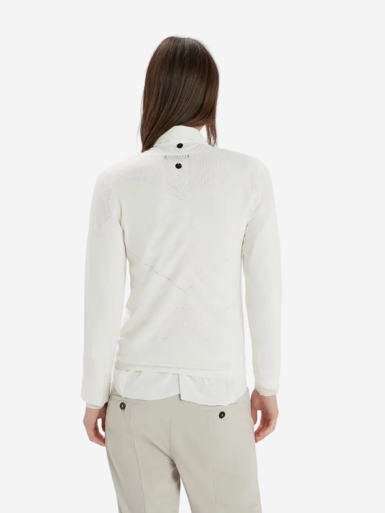 Person wearing a white long-sleeve shirt and beige pants on a white background