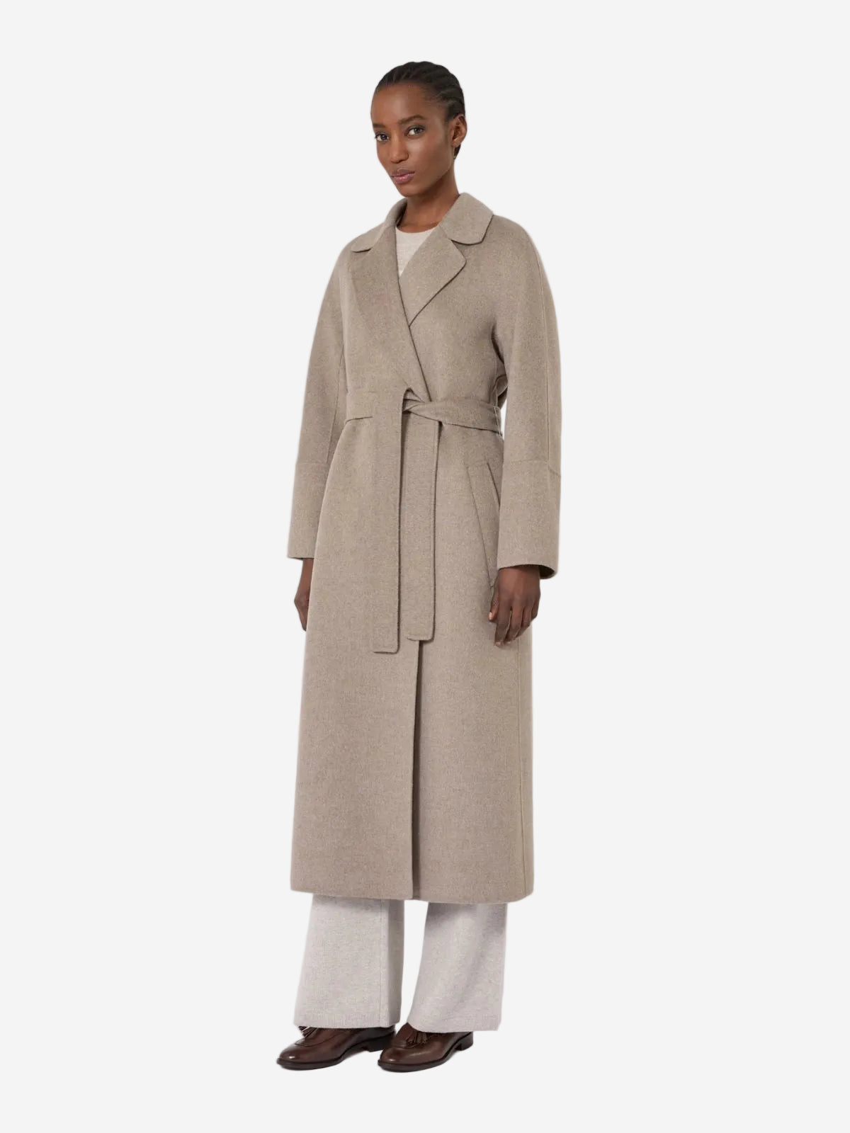 Woman wearing a beige trench coat on a white background