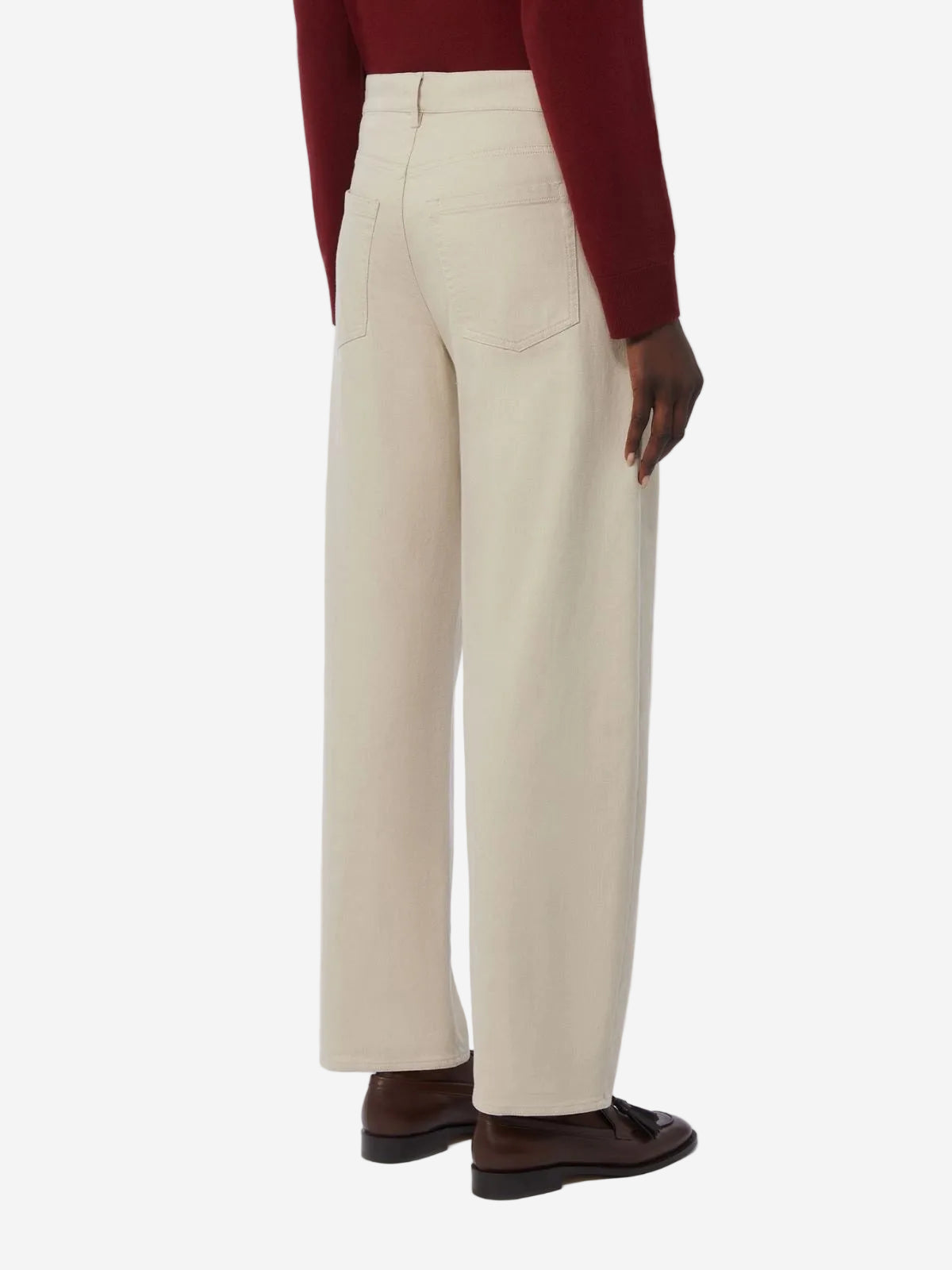 Beige pants worn by a person on a white background