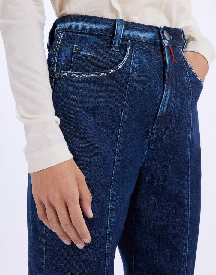 Close-up of the HIGH Fairness jeans showing contrast stitched pocket trim, red waistband detail and front centre seam