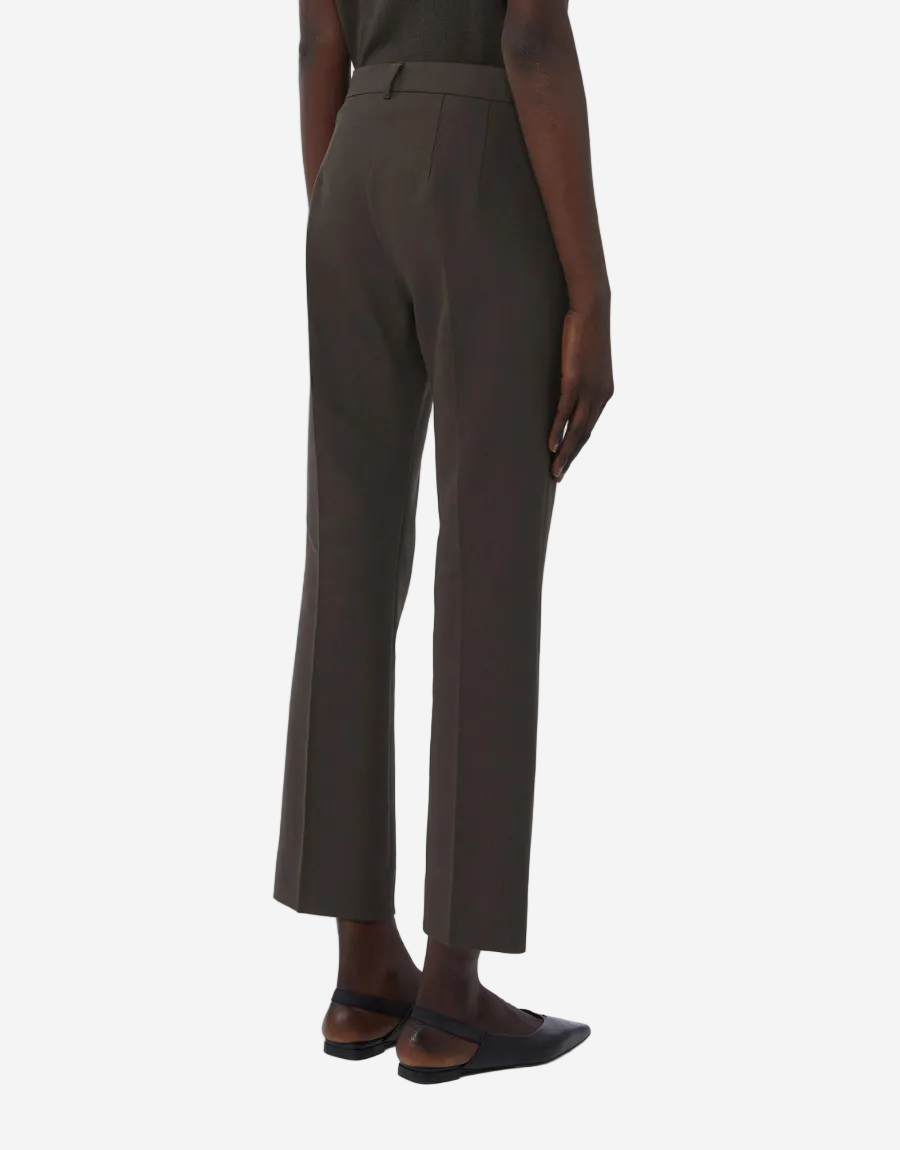 Brown pants worn by a person on a white background