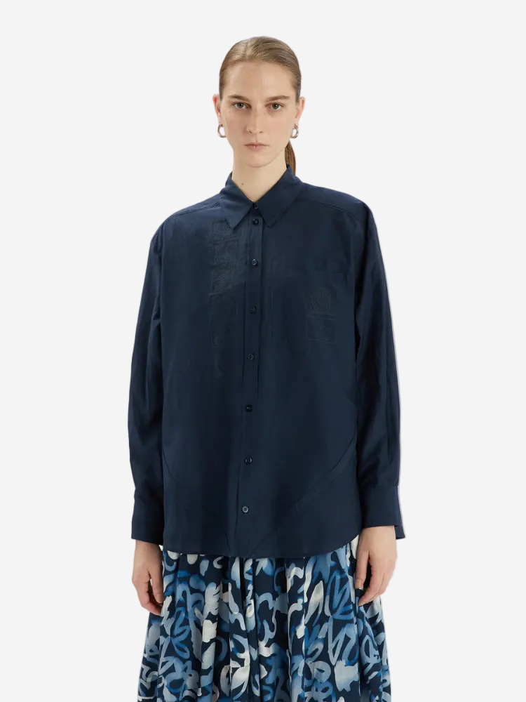 Person wearing a navy blue shirt with a white background