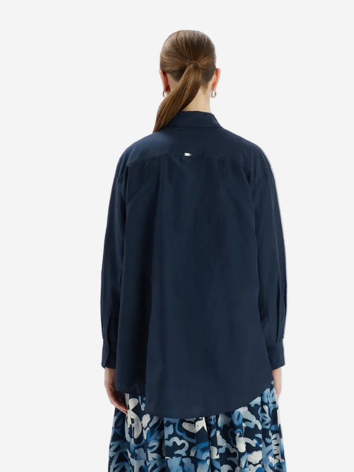 Person wearing a navy blue shirt with a white background