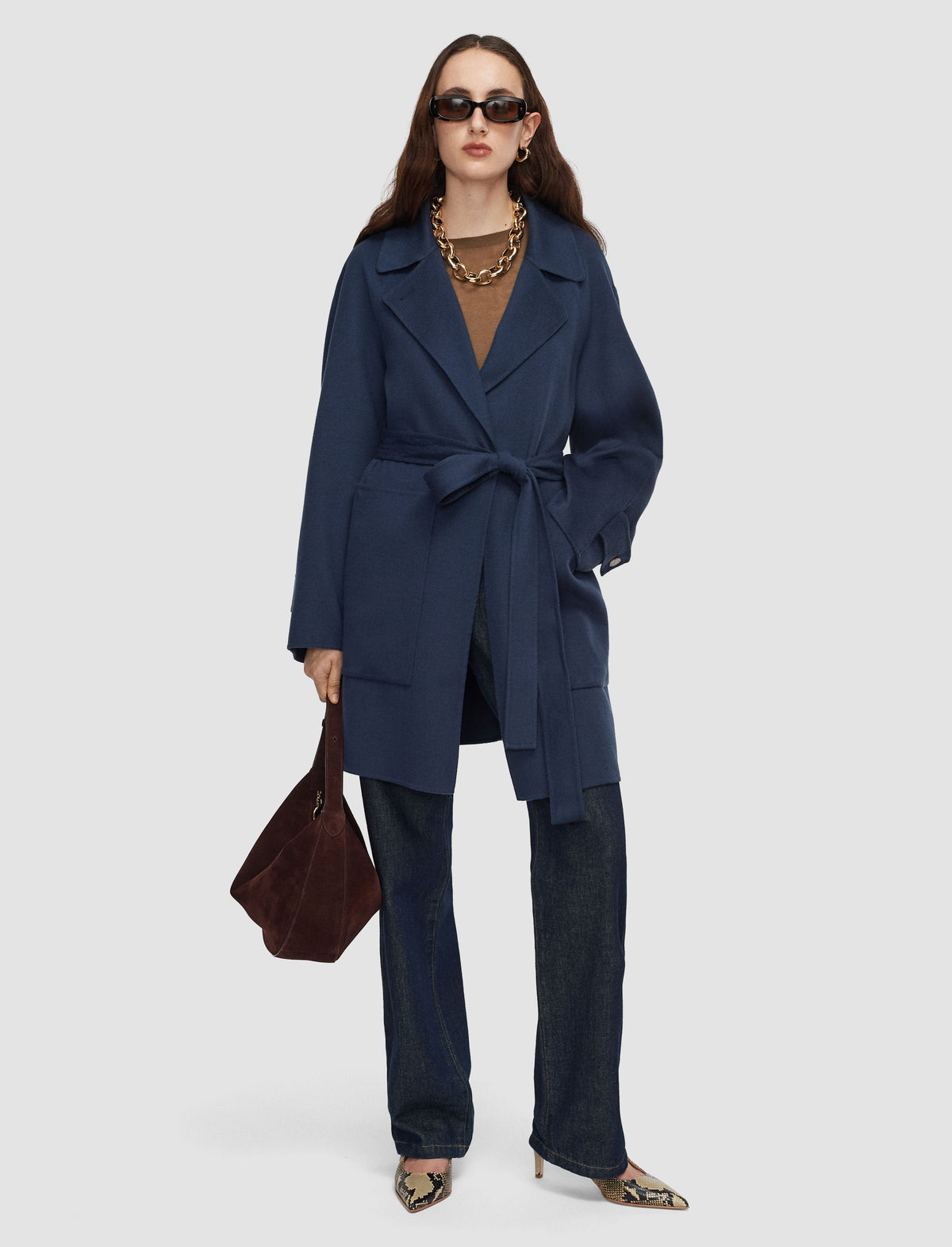 Model wearing wool blue trench coat by Joseph. 