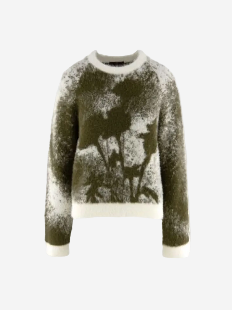 Green sweater with abstract pattern on a white background
