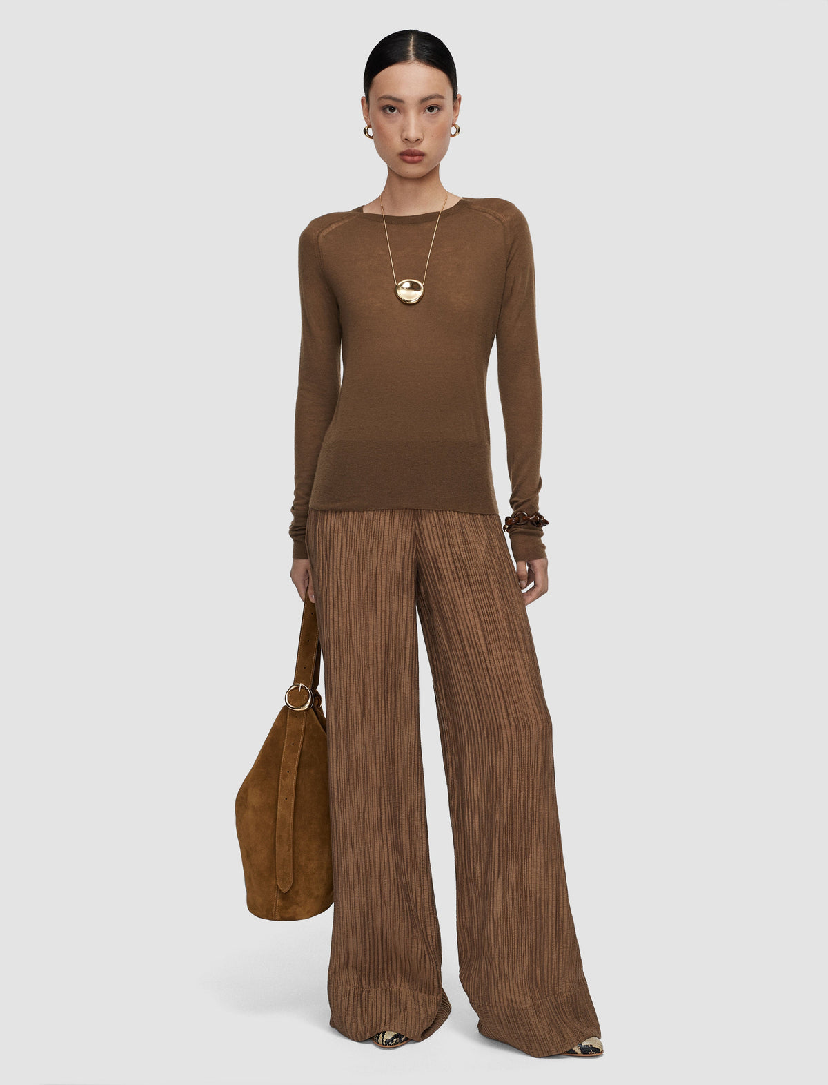 Model wearing a taupe brown knit sweater by Joseph. 