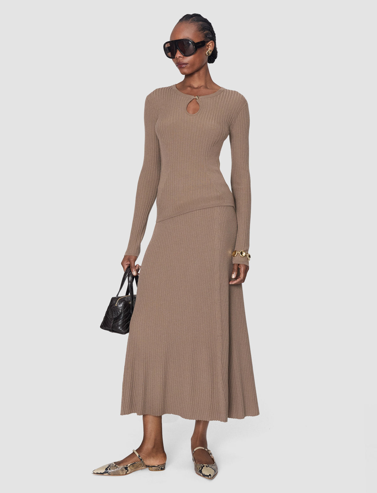 Model wearing a tan colour ribbed long woollen skirt by Joseph with a matching tan long sleeve top. 