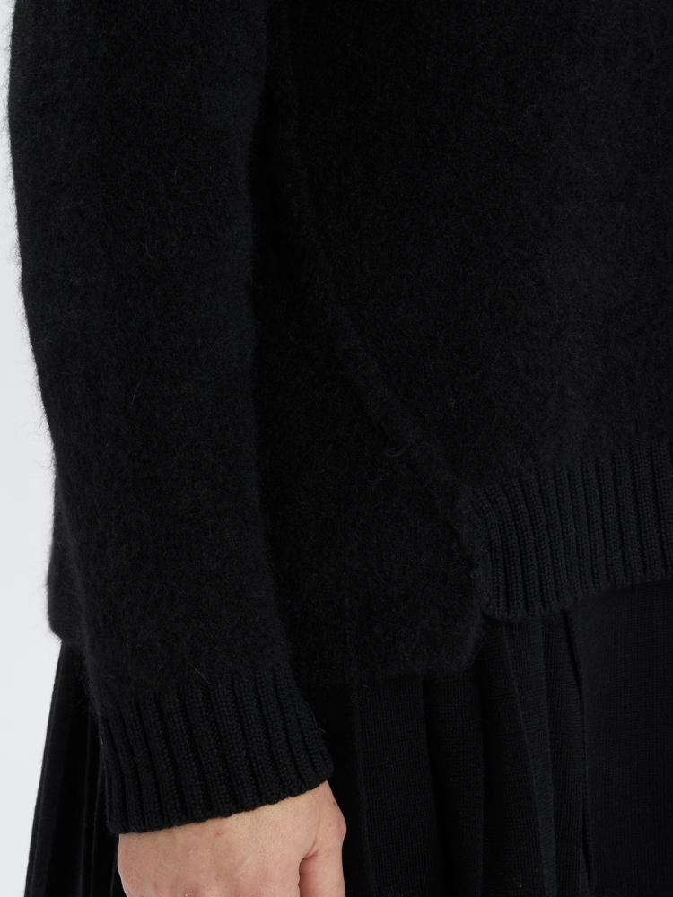 Black sweater with a white background